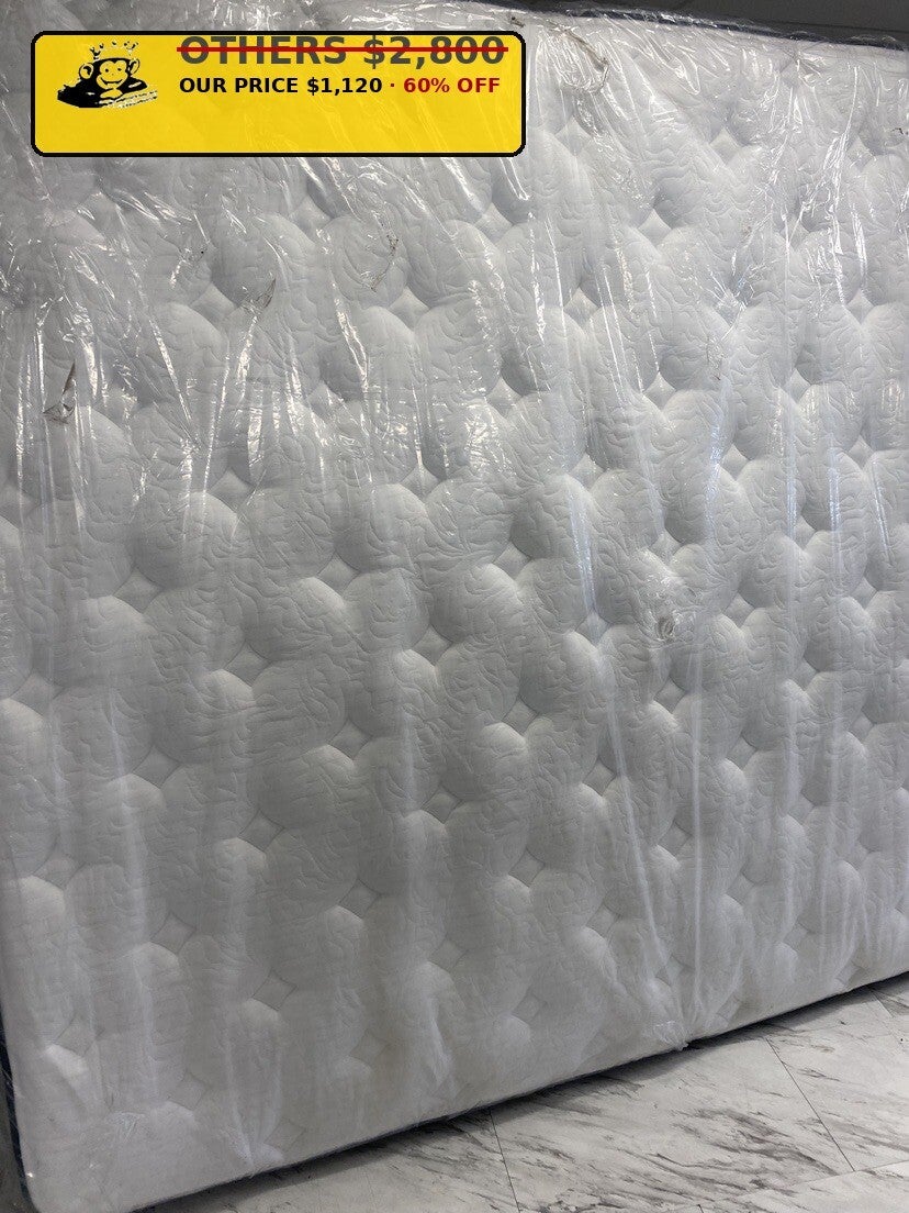 White diamond quilt mattress standing wrapped at Mattress Monkey Liquidation, mattress store in Chilliwack BC