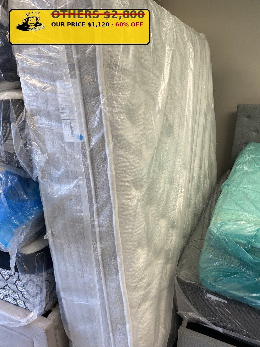 Ivory quilted mattress standing wrapped at Mattress Monkey Liquidation, mattress store in Chilliwack BC