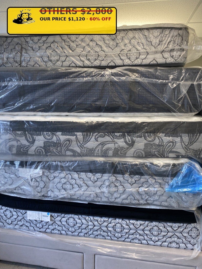 Stack of damask-patterned wrapped mattresses at Mattress Monkey Liquidation, mattress store in Chilliwack BC