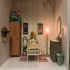 Mini Rabbit standing, next to the bed. Happy in it's new owners bedroom. 