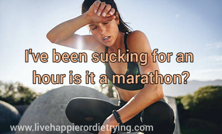 A woman sweating and tired. Rubbing her face with the back of her hand