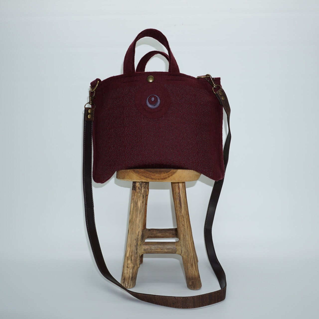 Bordeauxrode handtas/ crossbodytas van wolvilt met siersteken