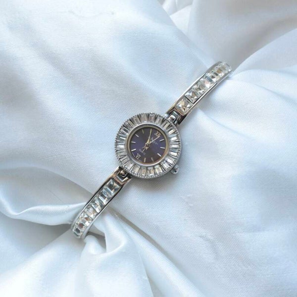 N. Moore 7.25” silver ticking watch