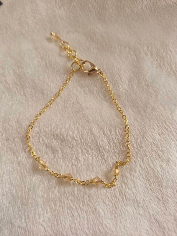 Armband goudkleurig kraal champagne