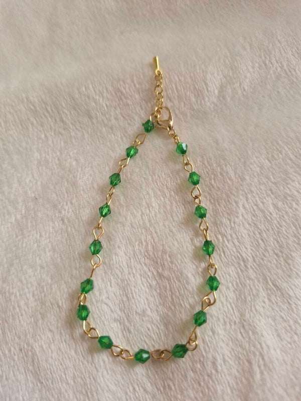 Armband goudkleurig kraal schakel groen