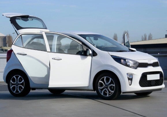 A white car with its doors and boot open