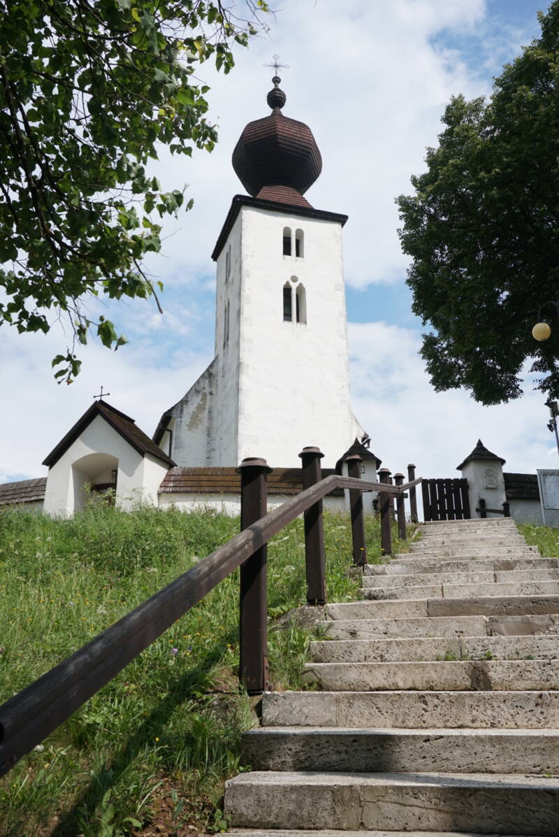 steps up a hill to a small white church