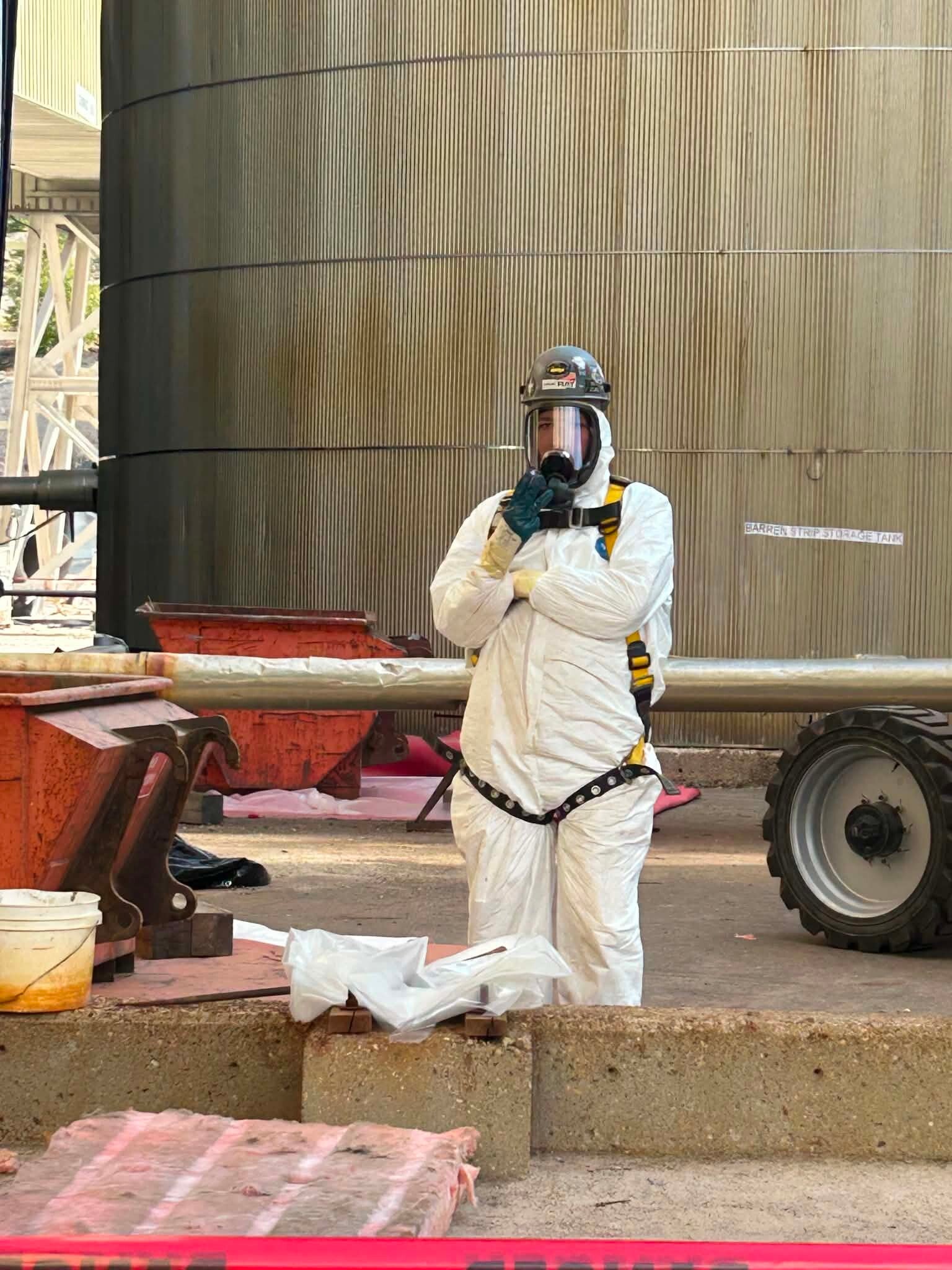 Safety Solutions Alberta | Success Safety Solutions | Image of a worker in full HASMAT gear