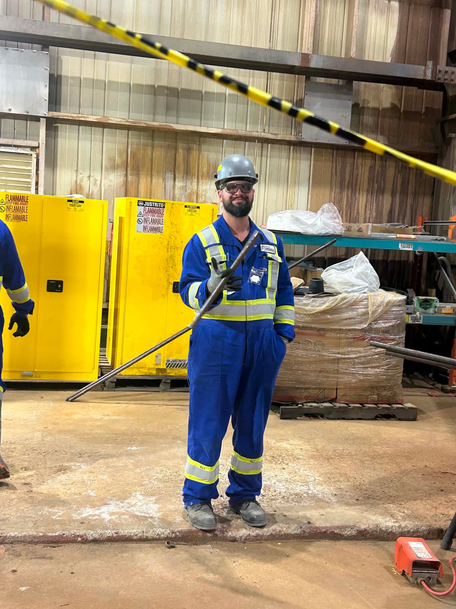 Professional SOP Writing | Image of a worker in coveralls smiling