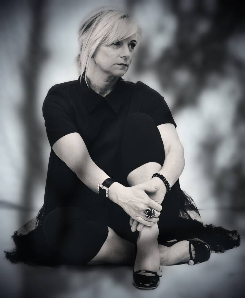 Zwart-wit portret van zittende vrouw – karaktervolle artistieke fotografie