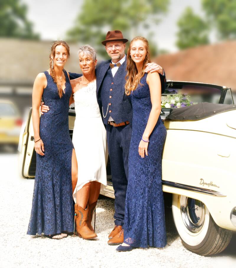 Bruidspaar met familie voor oldtimer – groepsfoto huwelijk