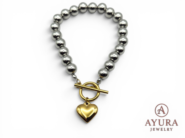 Dames armband 'Dani' – RVS armband met zilverkleurige kralen en gouden hartbedel