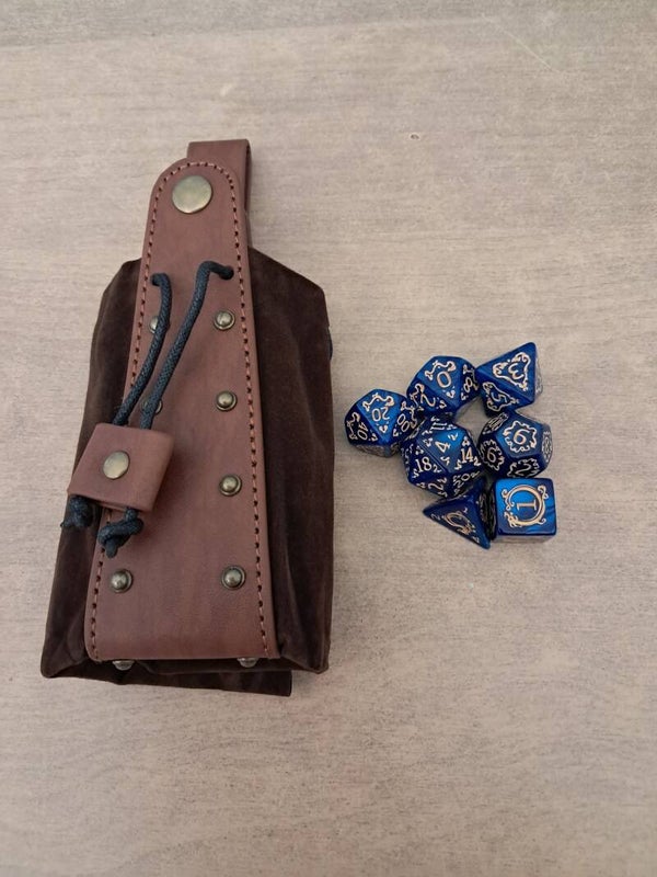 Brown leather dice bag with rivets and d&d dragon dice