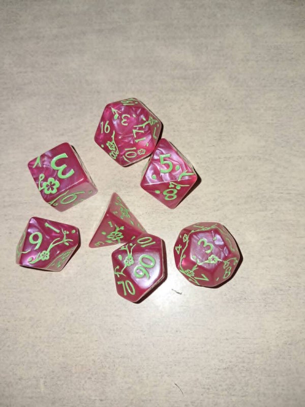 Red d&d dice with green blossom