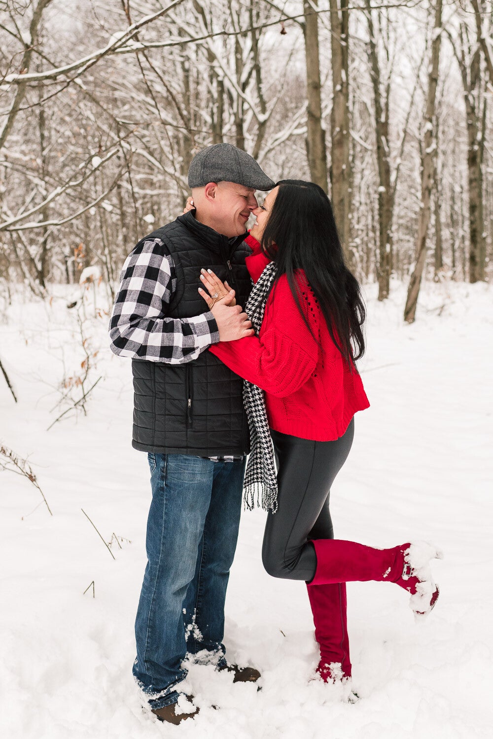 engaged-couple-kissiing-in-the-snow-in-the-woods-1-standard.jpg