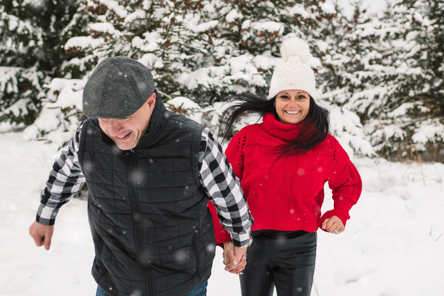 engaged-couple-running-holding-hands-in-the-snow-1-standard.jpg