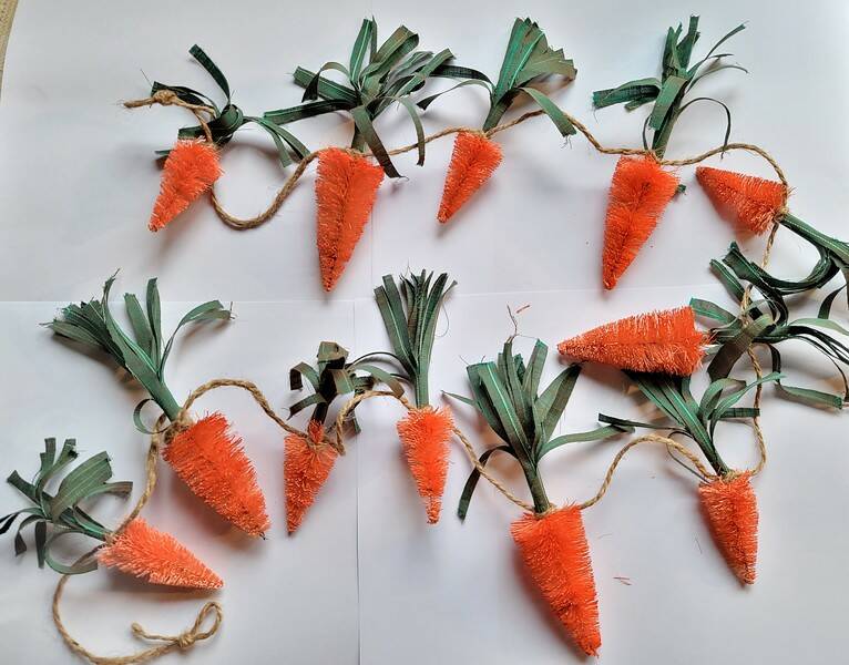 Shop Easter Decor! Carrot garlands, bunny bottle brush trees.