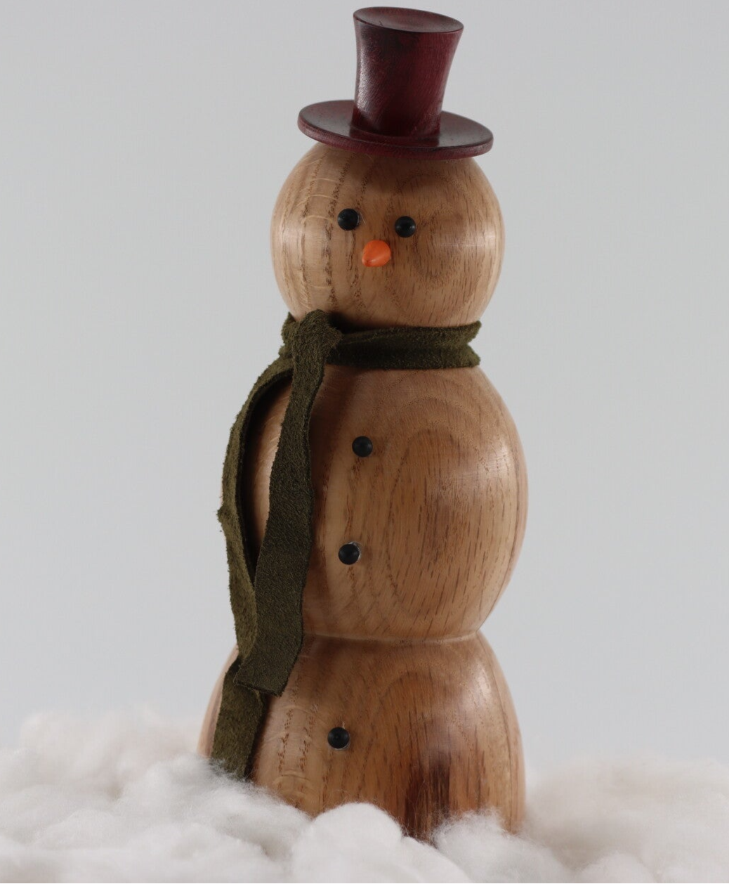 Sneeuwpop gemaakt van Eikenhout met een hoedje van Purperharthout en een sjaaltje van leer.