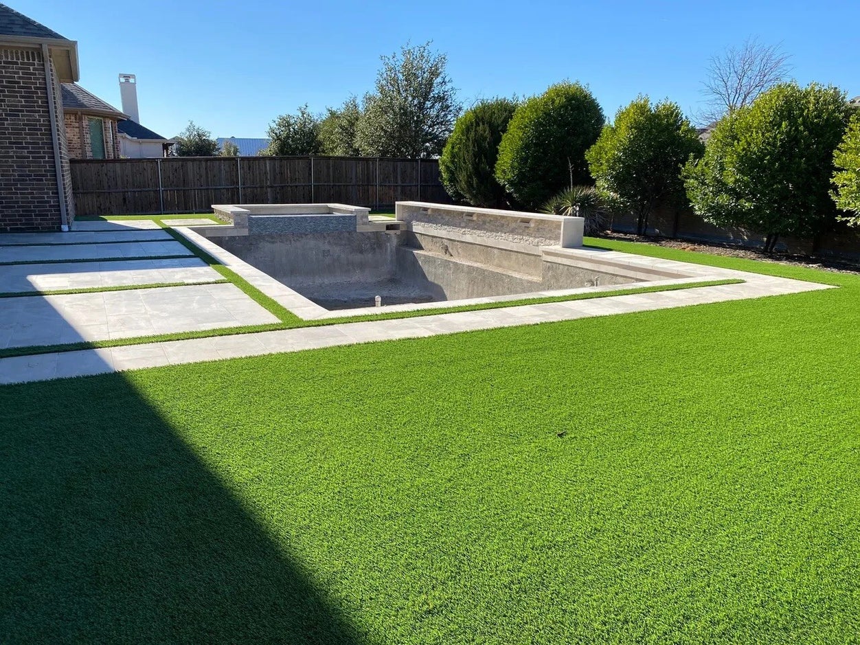 Premium artificial turf installation with paver walkway in a Fort Worth backyard