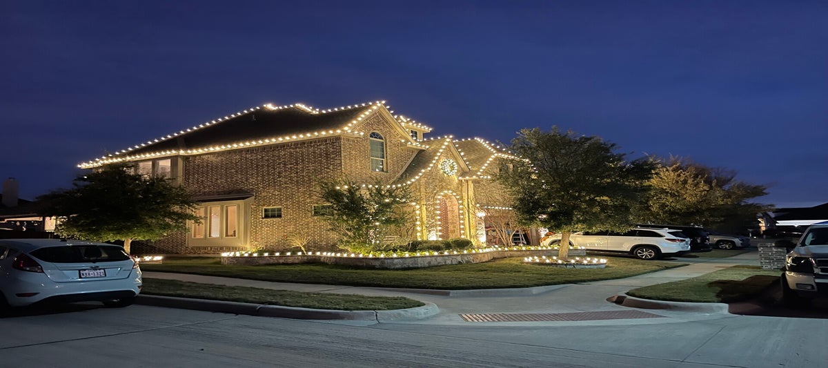 Professional warm white Christmas light installation on luxury home in Colleyville Texas