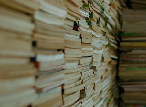 Stacks of old military documents symbolising the complexity of British Army service number systems