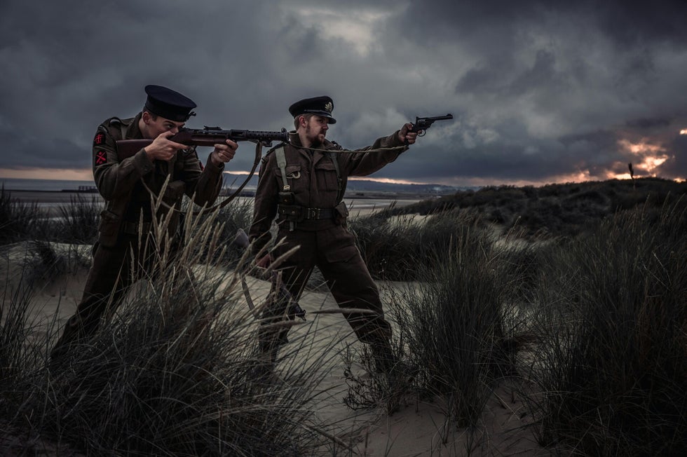 Reenactors in wartime uniform searching dunes – visual guide for identifying an ancestor’s British Army regiment