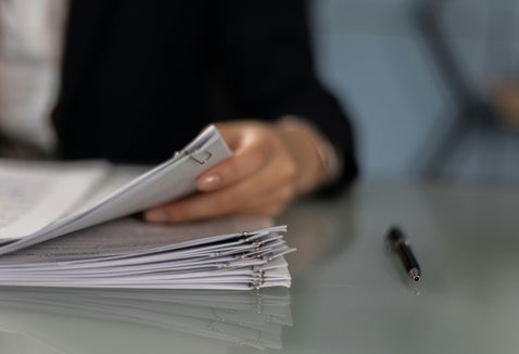Researcher examining a stack of documents, symbolising the process of searching British military records and service files