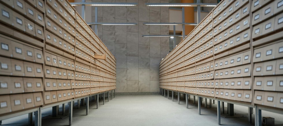 ows of archive boxes in a research facility – ideal for uncovering UK military service records