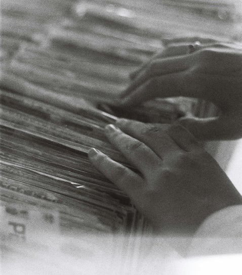 Black and white photo of researcher looking through historical service records to trace British Army history