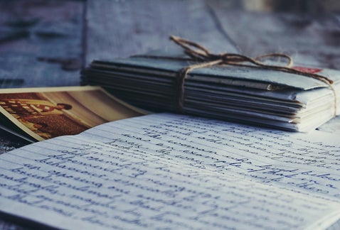 Stack of old letters and a vintage photo, representing personal research into British military records and family history