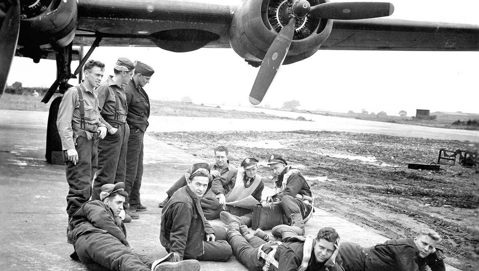 WWII RAF aircrew resting beside bomber aircraft – used to illustrate RAF squadron record research
