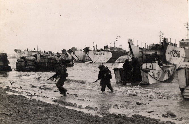British troops disembarking from landing craft during D-Day assault, Normandy beach, WWII military records context
