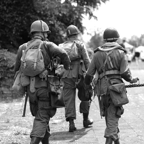 Group of WWII soldiers on patrol, useful for identifying uniforms and tracing military ancestors in World War Two records