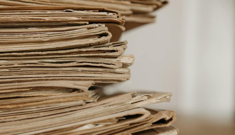 Stack of aged wartime documents representing British WWII service records held in military archives