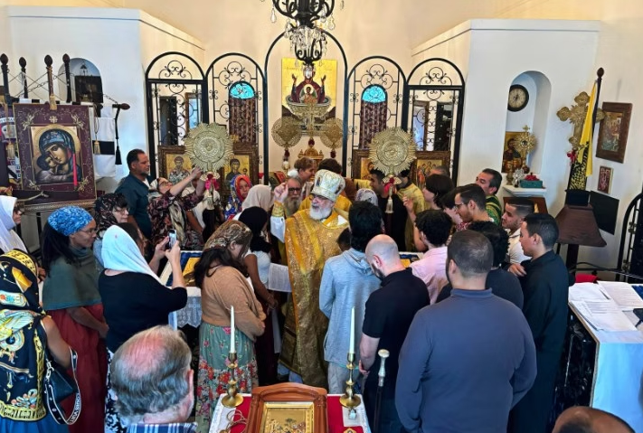 inside of orthodox chapel with faithful standing