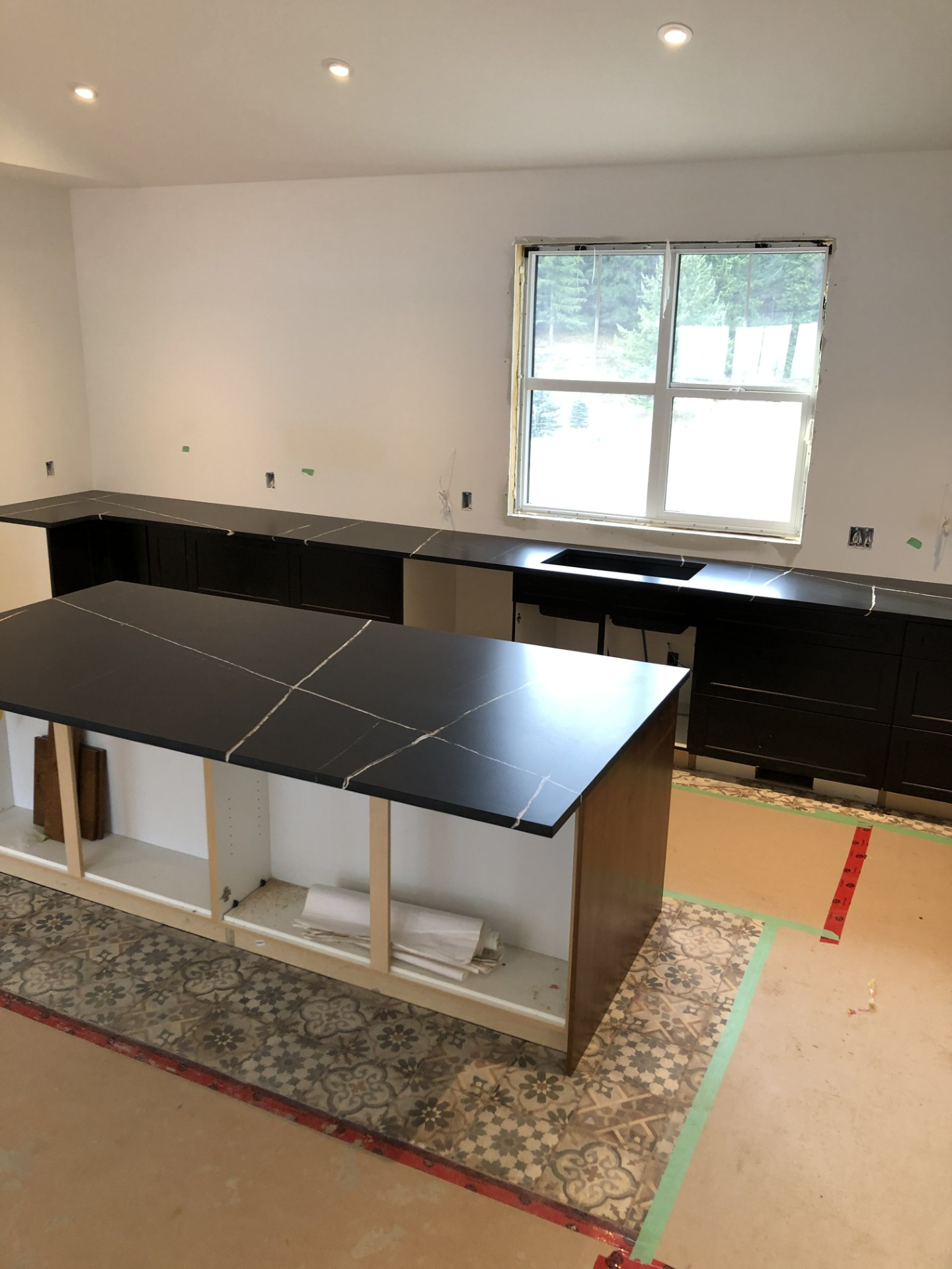 Dark quartz countertop installation in progress, custom kitchen renovation