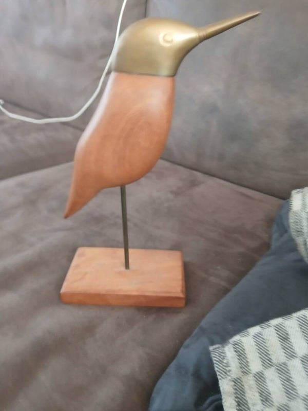 houten vogel met koperen kop