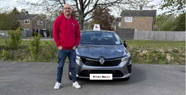 A photograph of David Wilkinson an award winning driving instructor based in Milton Keynes, Newport Pagnell and Cranfield. He is stood next to his car.
