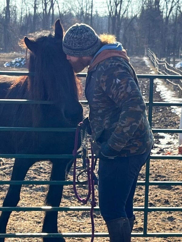 Joshua Knowles kissing Friesian Horse Minka