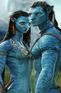 Two blue-skinned, humanoid characters from the Avatar movie, with long hair and yellow eyes, standing close together in a vibrant forest.