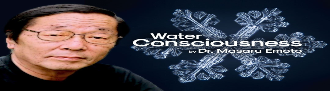 Dr. Masaru Emoto beside a magnified ice crystal snowflake — the Japanese water scientist who proved that human thoughts, words, and emotions can physically alter the molecular structure of water