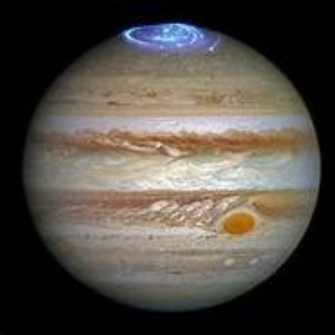 Jupiter with colorful bands and a bright aurora at the top of the planet. 