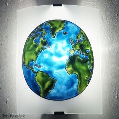 cette applique blanche est décorée du motif de la planète terre en verte et bleu.