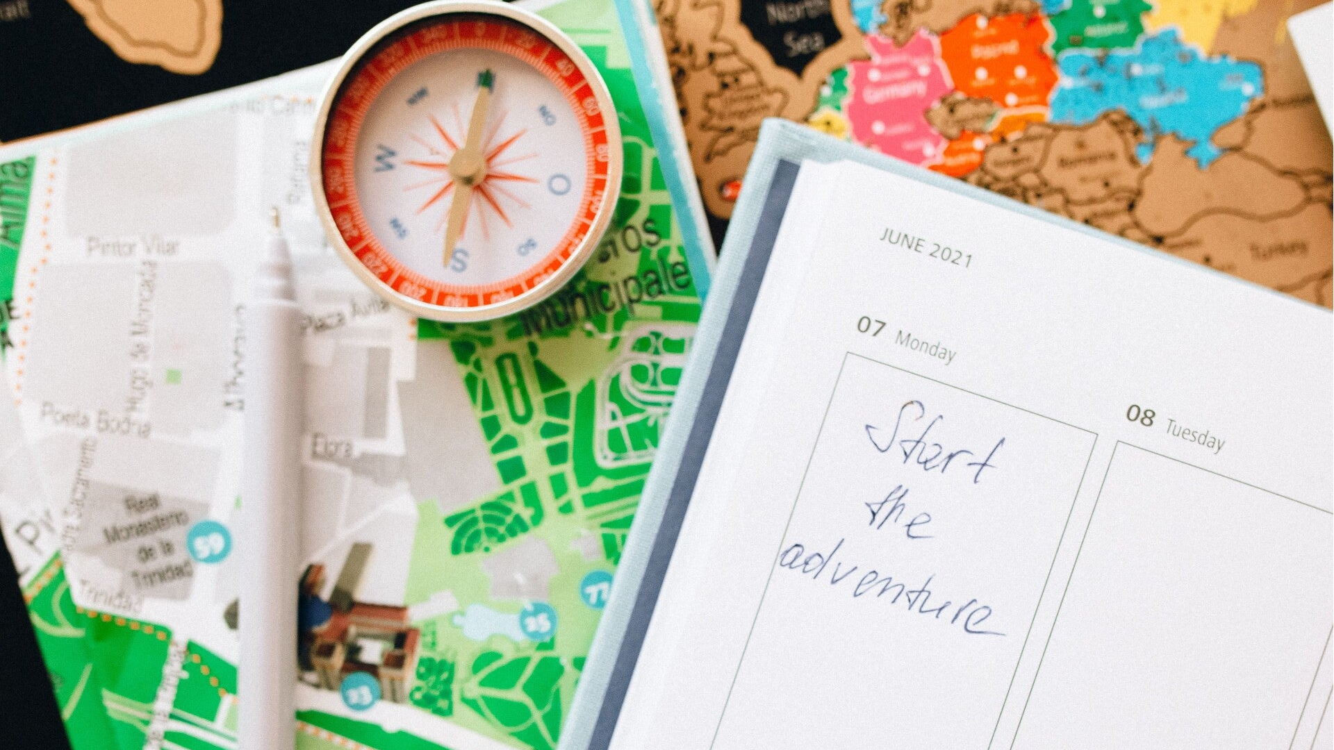 Travel planner, map and compass arranged for trip planning