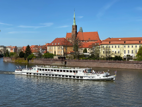 River cruise ship sailing through a scenic European waterway