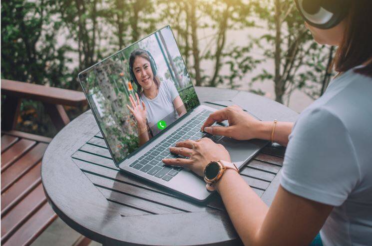 Hands Typing on Laptop – Accelerate Your English Fluency with Regular Conversation Practice.