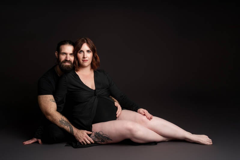 Artiestieke zwangerschapsfotografie in Tienen - zwangere vrouw in elegante jurk in professionele studio