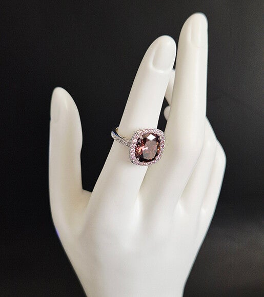 Oval Garnet surrounded by smaller accent stones and sterling silver ring