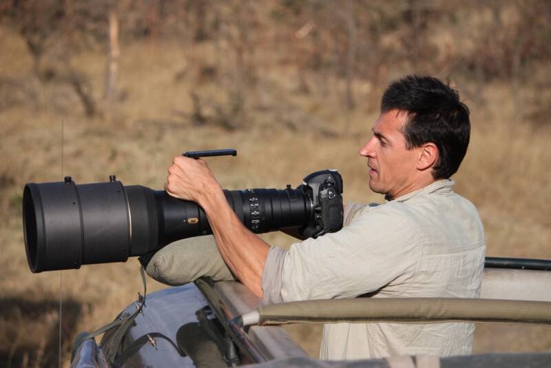 Marcel Romdane — wildlife photographer, self-declared narrator of chaos, and future bush pilot — sighted in the Maasai Mara with a camera worth more than a Kenyan village’s annual income. From Riches to Rags, Part 1.