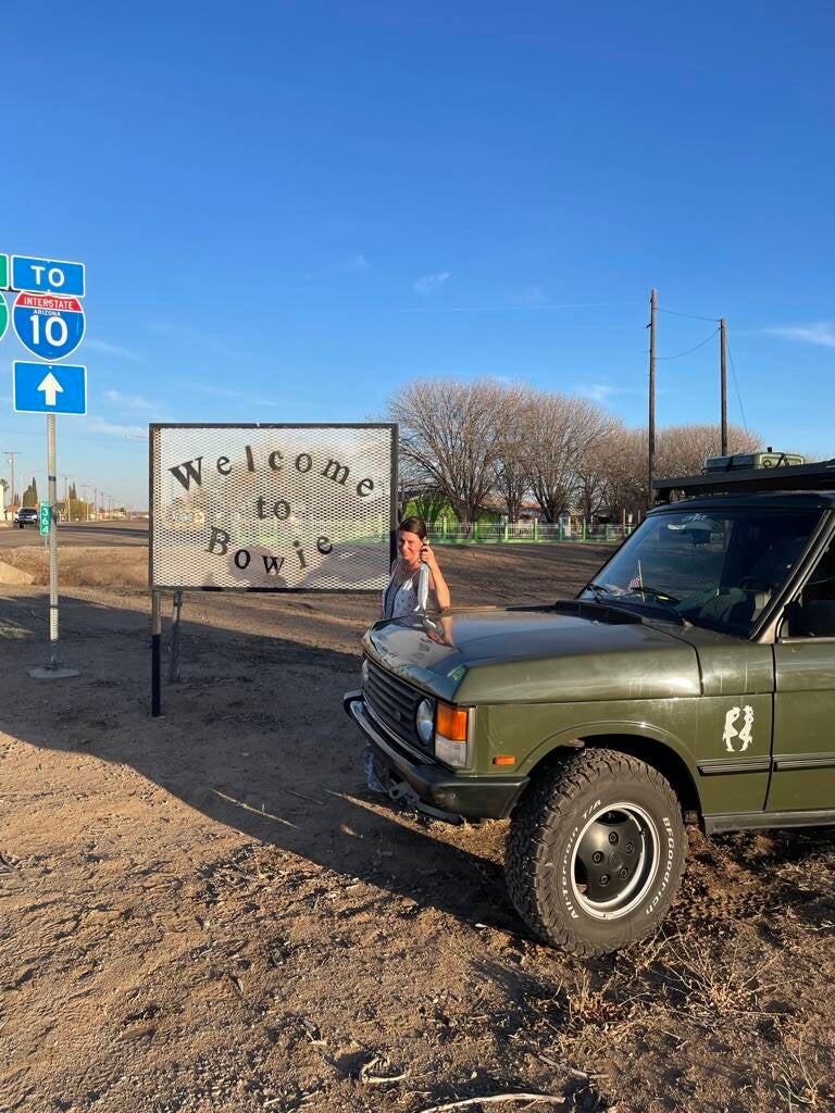Nicole Romdane with the Range Rover Classic in Bowie, Arizona — the cursed British car that turned a road trip into chaos, featured in What Could Possibly Go Wrong on Romdane Travel Tales.